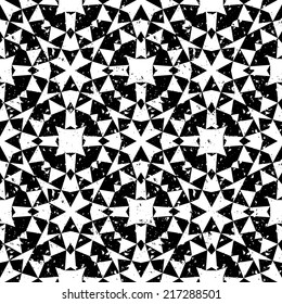 Grunge seamless geometric pattern in modern hipster style with small triangles and abstract stars in black and white. Vector background with used old scratched texture.