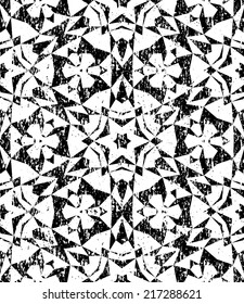 Grunge seamless geometric pattern in modern hipster style with small triangles and abstract stars in black and white. Vector background with used old scratched texture.