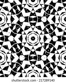 Grunge seamless geometric pattern in modern hipster style with small triangles and abstract stars in black and white. Vector background with used old scratched texture.