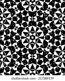 Grunge seamless geometric pattern in modern hipster style with small triangles and abstract stars in black and white. Vector background with used old scratched texture.
