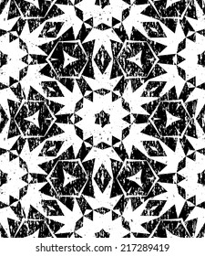 Grunge seamless geometric pattern in modern hipster style with small triangles and abstract stars in black and white. Vector background with used old scratched texture.