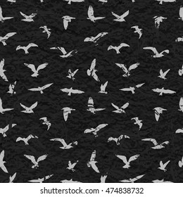 Grunge seamless pattern of flying birds black background. Vector illustration