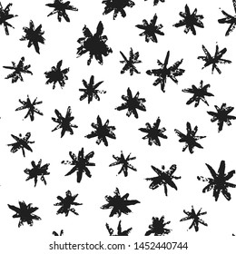 Grunge stars seamless pattern. Hand drawn paint brush seamless pattern. Black ink stains star wallpaper on white background.