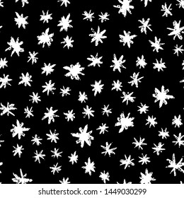 Grunge stars seamless pattern. White ink stains star wallpaper on black background. Hand drawn paint brush seamless pattern.
