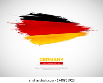 Grunge style brush painted Germany country flag illustration with german unity day typography. Artistic watercolor brush flag vector