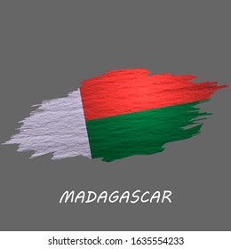 Grunge styled flag of Madagascar. Brush stroke background