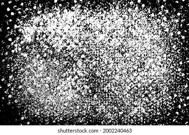 Grunge texture is black and white. The background is made of dirt, chips, scuffs, and wear. Old vintage surface splattered with ink. Soiled backdrop template