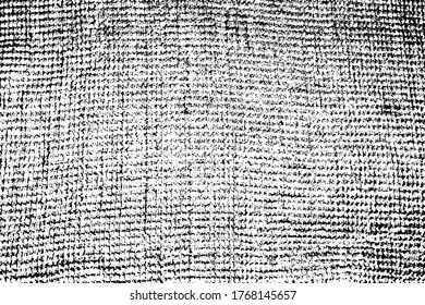 Grunge texture of uneven rough fabric. Monochrome background of a waffle towel with spots, noise and grain. Overlay template. Vector illustration