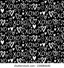 Grunge vector seamless pattern with hand painted hearts and words xoxo. Ditsy print for valentines day wrapping paper decor or wedding invitation card background in black and white colors