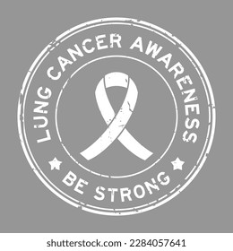 Grunge white lung cancer awareness be strong word with ribbon banner as round seal stamp on gray background 
