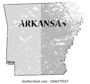 A grunged Arkansas state outline with the date of statehood isolated on a white background