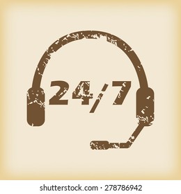Grungy brown icon with headset and text 24 per 7, on beige background