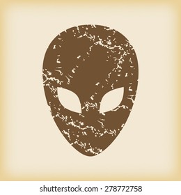 Grungy brown icon with image of alien head, on beige background