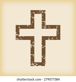 Grungy brown icon with image of christian cross, on beige background
