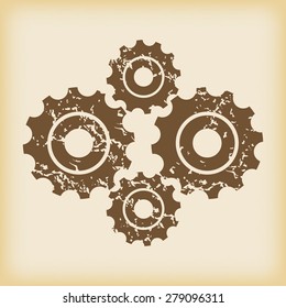 Grungy brown icon with image of four cogs, on beige background