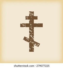 Grungy brown icon with image of orthodox cross, on beige background