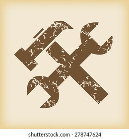 Grungy brown icon with image of wrench and hammer, on beige background