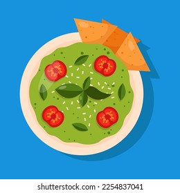 Guacamole with nachos. Mexican dip isolated on blue background.