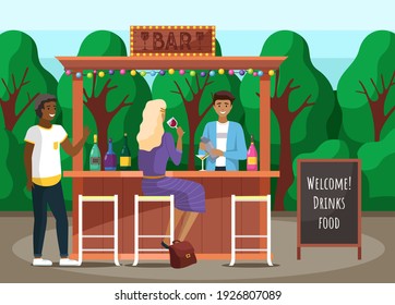 Guests are relaxing in street outdoor bar. Restaurant or bar on background of forest. Barman mixes drinks. Bartender making alcohol coocktails. Girl is drinking wine and communicating with guy