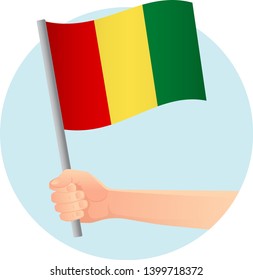 Guinea flag in hand. Patriotic background. National flag of Guinea vector illustration