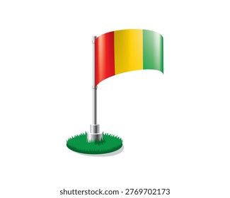 Guinean flag on a flagpole mounted on the grass