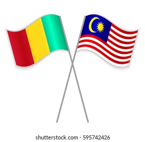 Guinean and Malaysian crossed flags. Guinea combined with Malaysia isolated on white. Language learning, international business or travel concept.