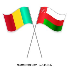 Guinean and Omani crossed flags. Guinea combined with Oman isolated on white. Language learning, international business or travel concept.