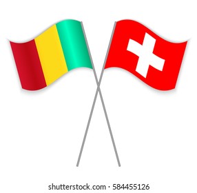 Guinean and Swiss crossed flags. Guinea combined with Switzerland isolated on white. Language learning, international business or travel concept.