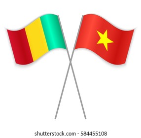 Guinean and Vietnamese crossed flags. Guinea combined with Vietnam isolated on white. Language learning, international business or travel concept.
