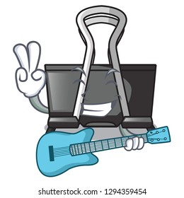 With guitar cartoon binder clip above wooden table