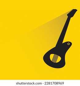 guitar with shadow on yellow background