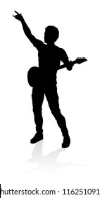 A guitarist musician in detailed silhouette playing his guitar musical instrument.