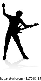 A guitarist musician in detailed silhouette playing his guitar musical instrument.