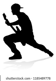 A guitarist musician in detailed silhouette playing his guitar musical instrument.