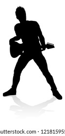 A guitarist musician in detailed silhouette playing his guitar musical instrument.