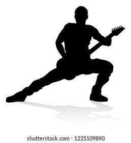 A guitarist musician in detailed silhouette playing his guitar musical instrument.