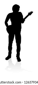 A guitarist musician in detailed silhouette playing his guitar musical instrument.