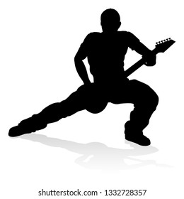 A guitarist musician in detailed silhouette playing his guitar musical instrument.