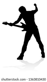 A guitarist musician in detailed silhouette playing his guitar musical instrument.