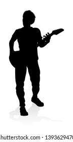 A guitarist musician in detailed silhouette playing his guitar musical instrument.