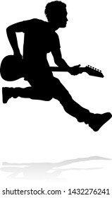 A guitarist musician in detailed silhouette playing his guitar musical instrument.