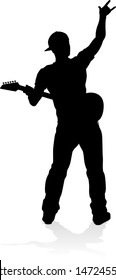 A guitarist musician in detailed silhouette playing his guitar musical instrument.