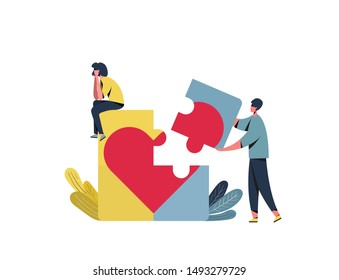 
A guy and a girl are assembling a puzzle with a heart.