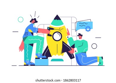 A guy and a girl are preparing a rocket for launch