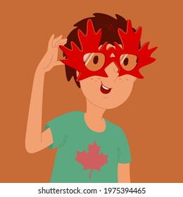 Guy in a green T-shirt and sunglasses. The frame of the glasses is made in the shape of maple leaves. Silhouette of a maple leaf on a t-shirt.