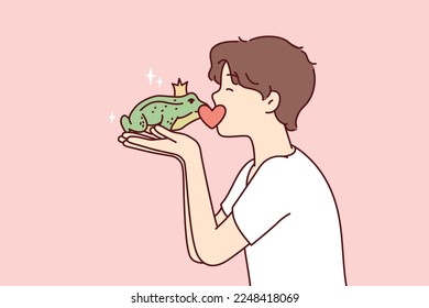 Guy kisses frog princess with crown on head, wishing that animal turned into beautiful girl. Teenage boy in white T-shirt holds green toad from fairy tales in hands. Flat vector illustration 