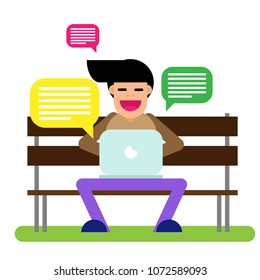 A guy with a laptop sits on a bench