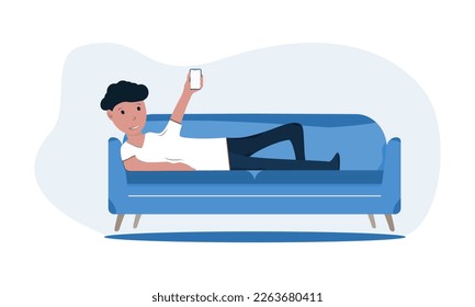 The guy is lying on the couch with the phone in his hands. The concept of online delivery, work at home
