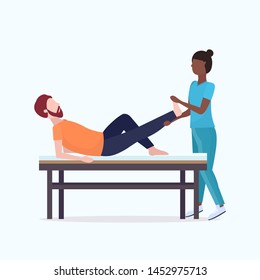 guy lying on massage bed african american masseuse therapist doing healing treatment massaging patient injured leg manual sport physical therapy concept full length vector illustration