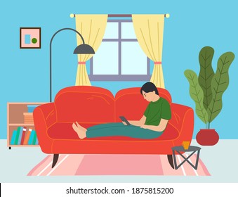 Guy lying on red sofa with smartphone, surfing Internet. Cozy home furnishings, windows, curtains, round coffee table, lush potted plant, bedside table with books, floor lamp. Living room items
